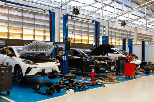 Automotive Repair Shop with Mechanic Servicing Multiple Vehicles in Modern Garage Facility