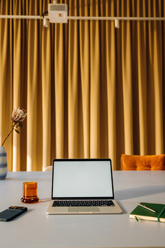 A laptop with a white screen on a desk