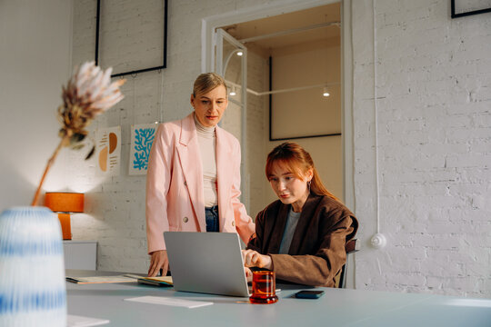 A woman uses a laptop in the office