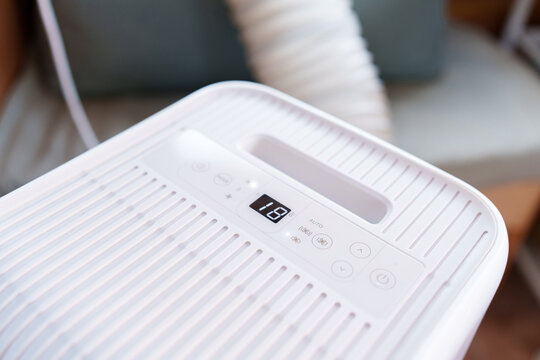 Close-up of a portable air conditioner digital display showing 18 degrees Celsius