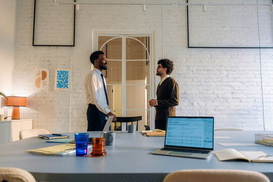 Two men are talking in the office