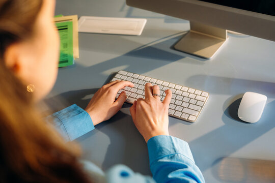 A woman uses a computer in the office