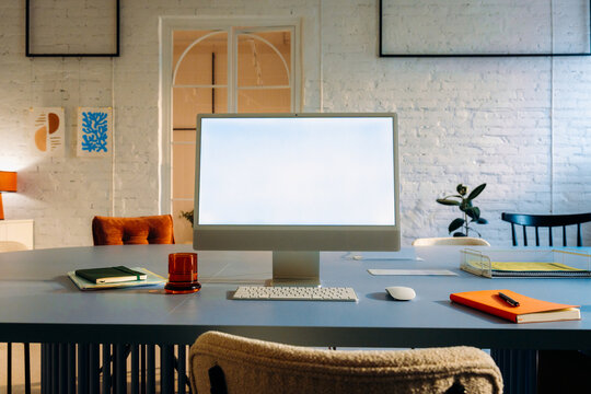A computer monitor with a white screen on the table