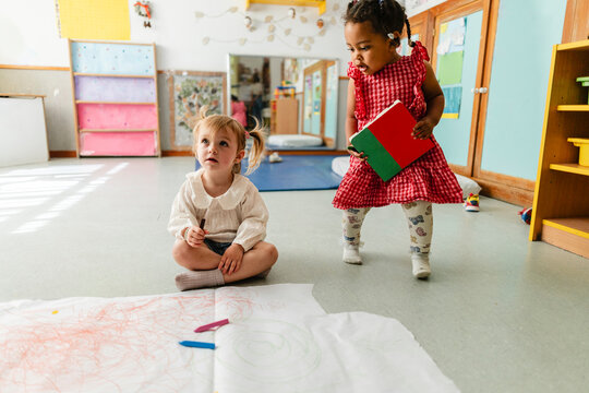 Diverse toddlers playing together in preschool classroom