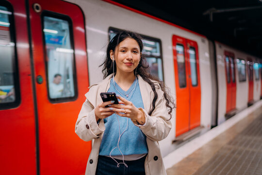 A woman using a mobile phone in the subway