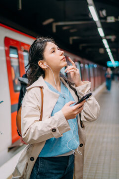 A woman standing on a subway platform