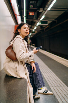 A woman using a mobile phone in the subway
