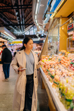 A woman buys fruits at the market