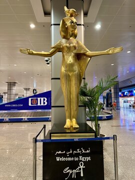Hurghada, Egypt &ndash; October 26, 2023: Golden replica statue of the ancient Egyptian goddess Serket welcomes arriving passengers inside Hurghada International Airport arrivals hall.