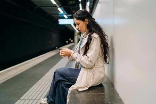 A woman using a mobile phone in the subway
