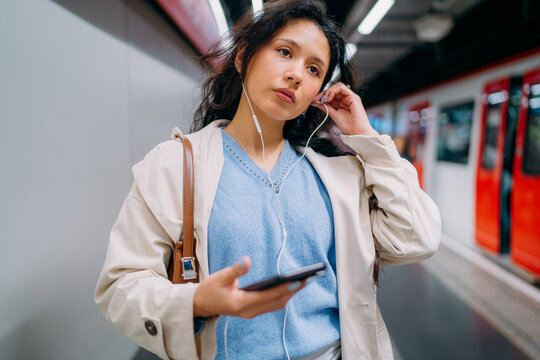 A woman using a mobile phone in the subway