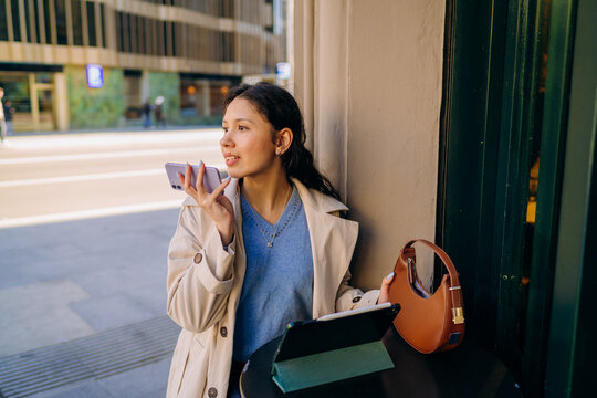 A woman using a tablet in the city