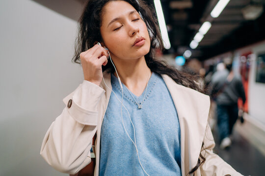 A woman using a mobile phone in the subway