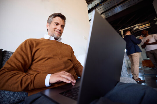 Man works on a laptop in a contemporary space