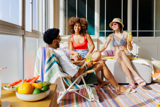 Diverse friends enjoying summer leisure with drinks and fruits
