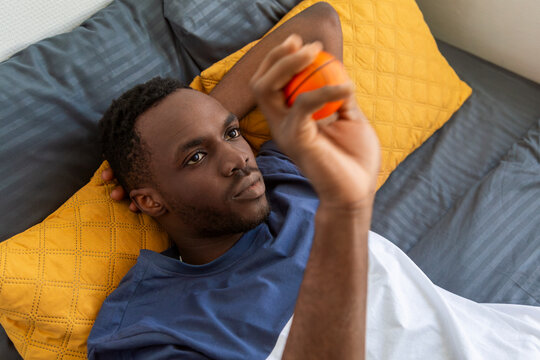 Man using smartphone while lying in bed