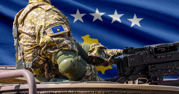 Kosovo flag with soldier at machinegun turret