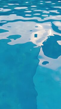 Sunlight dances on calm blue water surface creating soft white reflections