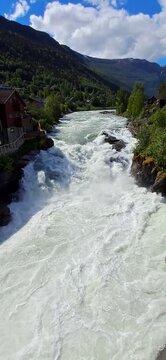Bovra River waterfall cascading into the Otta River in Lom, Norway.