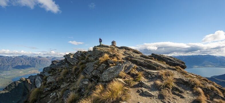 Hiker at the summit of Ben Lomond, views of Lake Wakatipu and The Remarkables mountain range, Southern Alps, Otago, South Island, New Zealand