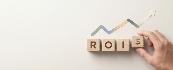Return on investment roi concept with hand arranging wooden blocks and increasing trend arrow investment