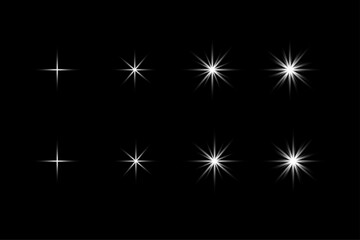 Fototapeta premium Collection of eight white starburst light effects on black background flare