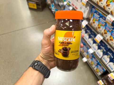 Nescafe Clasico Instant Coffee Jar Held In Supermarket Aisle