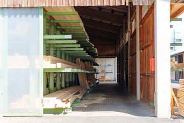 Obraz premium Timber Planks Stored on Green Metal Racking System