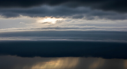 Fototapeta premium Dramatic Sunrise Over Calm Ocean with Cloudy Sky and Golden Light Reflection