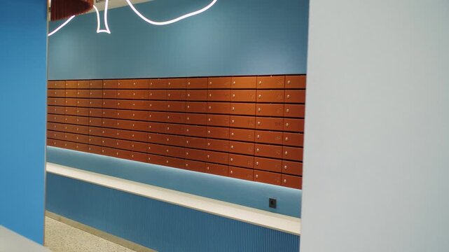Modern apartment lobby with wall of mailboxes