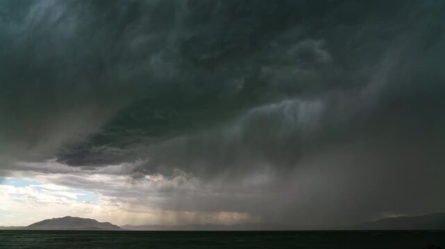Time-lapse of rainstorm moving over Utah Lake as lightning strikes during summer monsoon season.