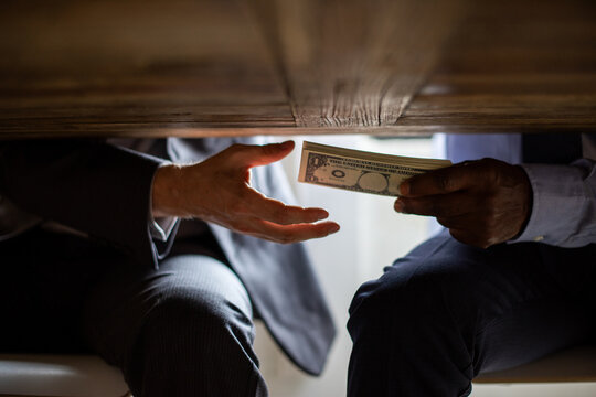 Secretive money exchange under table