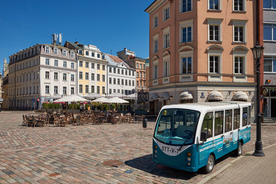 Historic Dome Square with tourist electric shuttle bus in Old Riga, Latvia.