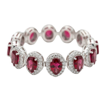 Luxurious platinum bracelet featuring pear-shaped deep red rubies with diamond pav&eacute; halos on a transparent background, elegant jewelry store display atmosphere