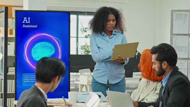 Diverse multiracial team planning new business strategy with AI marketing consultant on multiple screens and documents in modern open office, corporate restructuring and transformation concept