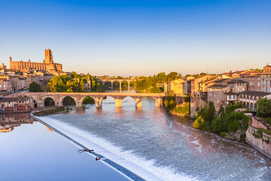 Bridges over the Tarn river and historic cathedral at sunrise in Albi, France