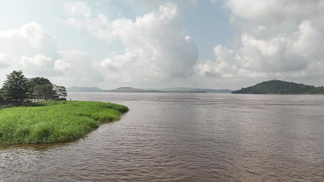 Congo River, DR Congo - wide river with grassy banks and distant hills, aerial drone view