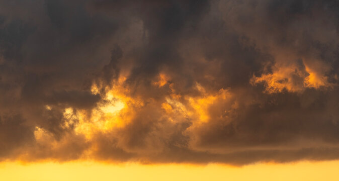 Sky with bright orange clouds after sunset. Sky background.