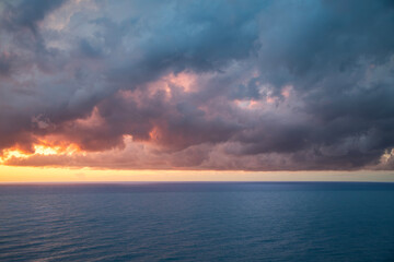 Obraz premium Sky with bright orange clouds after sunset. Sky background.
