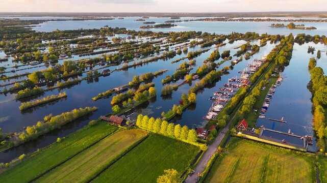 Aerial drone view the harbour of Scheendijk Loosdrechtse Plassen, a floating village in the Netherlands at sunset. High quality 4k footage
