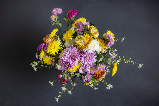 Vibrant autumn flowers bouquet on black background.