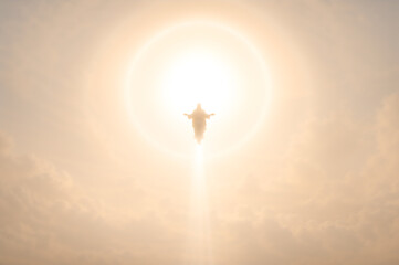 Jesus Christ ascending into heaven. Messiah rising into light with arms outstretched. Christian religious concept of Ascension Day, spiritual resurrection, divine glory and salvation.