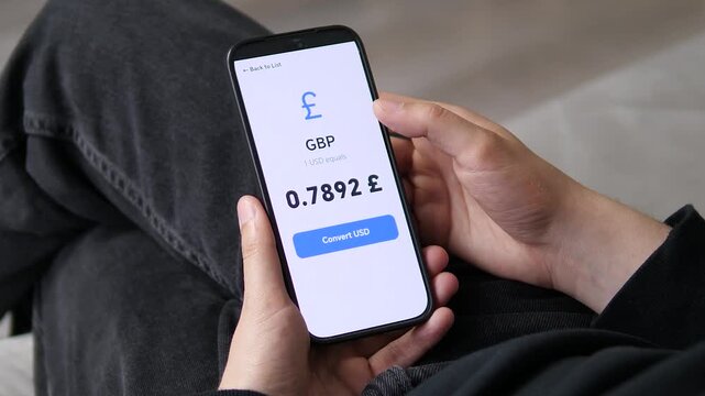 User focusing on the specific GBP to USD exchange rate of 0.7892. The large digits make the value instantly readable. Ideal for currency localization, precision trading, and focused financial stock