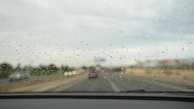 Raindrops on Car Windshield During Rainy Drive Close Up
