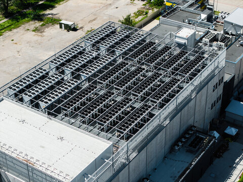 Riga, Latvia - 24 June 2026: Aerial view of the EU North Riga LV DC1 data center, featuring rows of industrial cooling units on the rooftop of a modern concrete building.