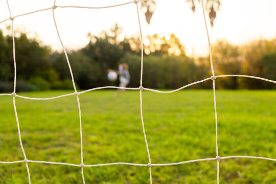 out of focus soccer ball and net