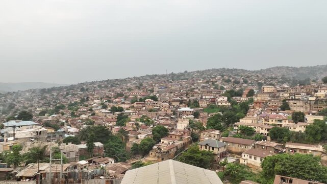 Matadi, DR Congo - a dense hillside neighborhood of rooftops, aerial drone view