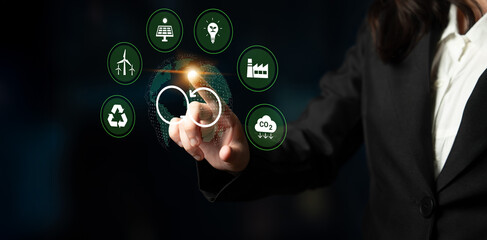 Obraz premium A professional businessperson interacts with digital icons representing sustainability and the circular economy, symbolizing future innovations in various sectors. Cyphers