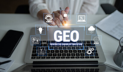 Obraz premium Focused Business Professional Engaging with Laptop Displaying Generative Engine Optimization Concept and Graphic Icons in Modern Workspace Environment Fluxor.