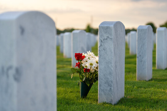 Army veteran cemetery with white headstones. Tombs of retired military soldiers. Memorial Day concept